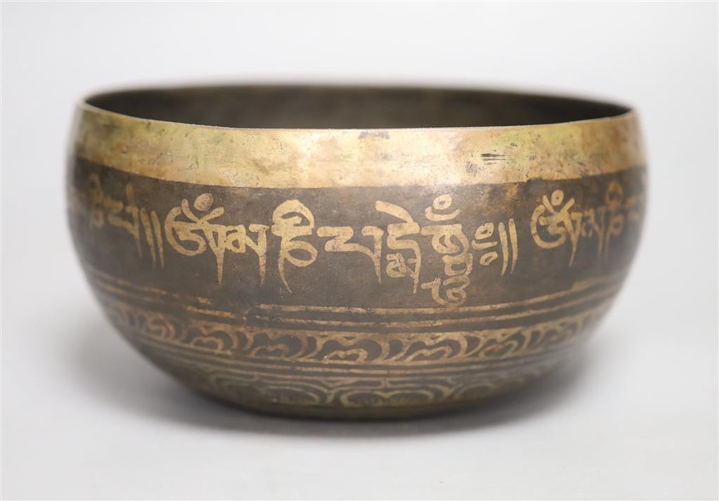 A Middle Eastern white metal and copper damascened bell, banded with foliate patterns and Arabic script Dia 18cm